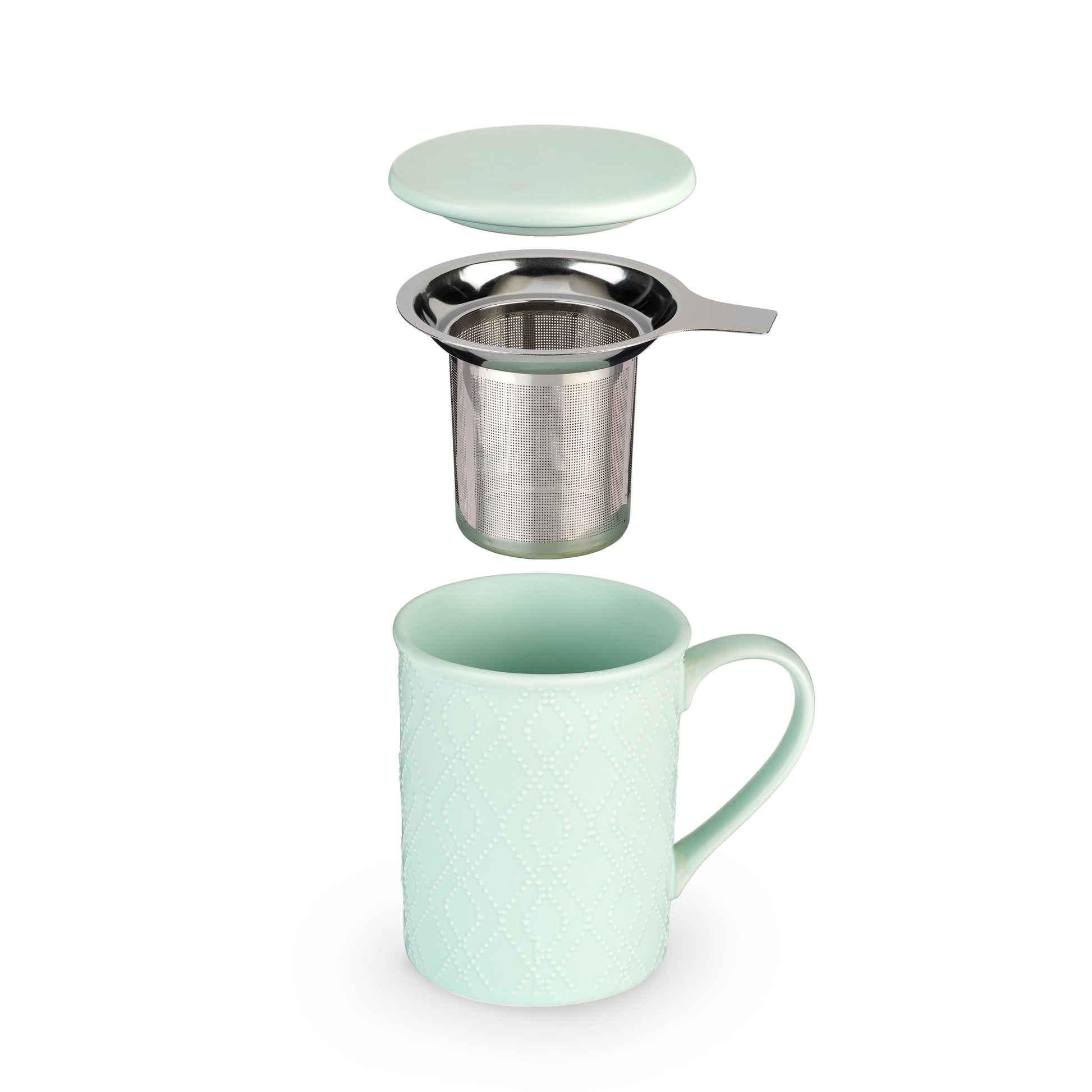 Mint green mug with metal tea infuser on a white background