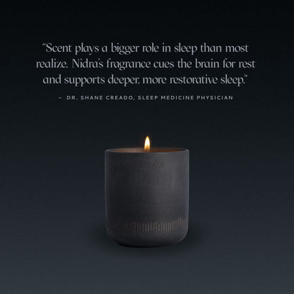 Caftari Nidras fragrance candle. Black candle with a quote from Dr. Shane Creado on a dark background