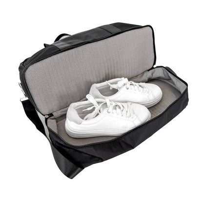 Black shoe bag with white sneakers inside on a white background