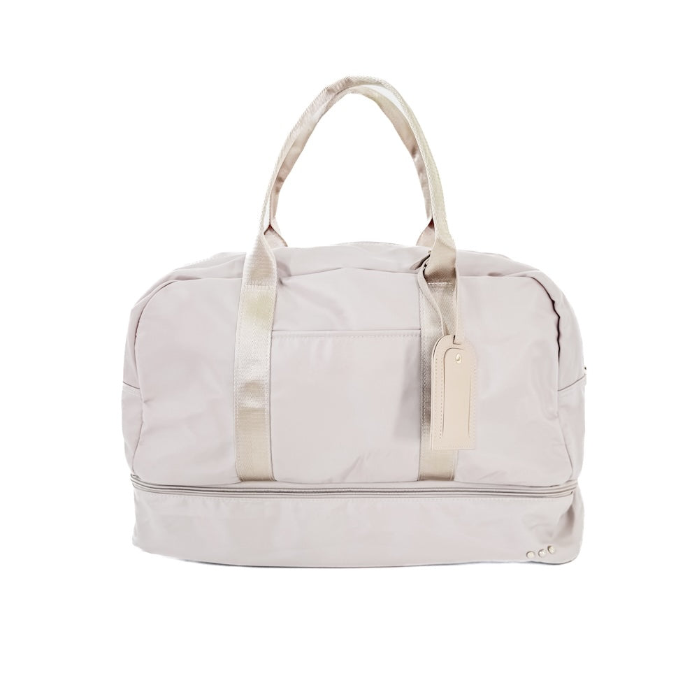 Light gray duffel bag with white handle and strap on a white background
