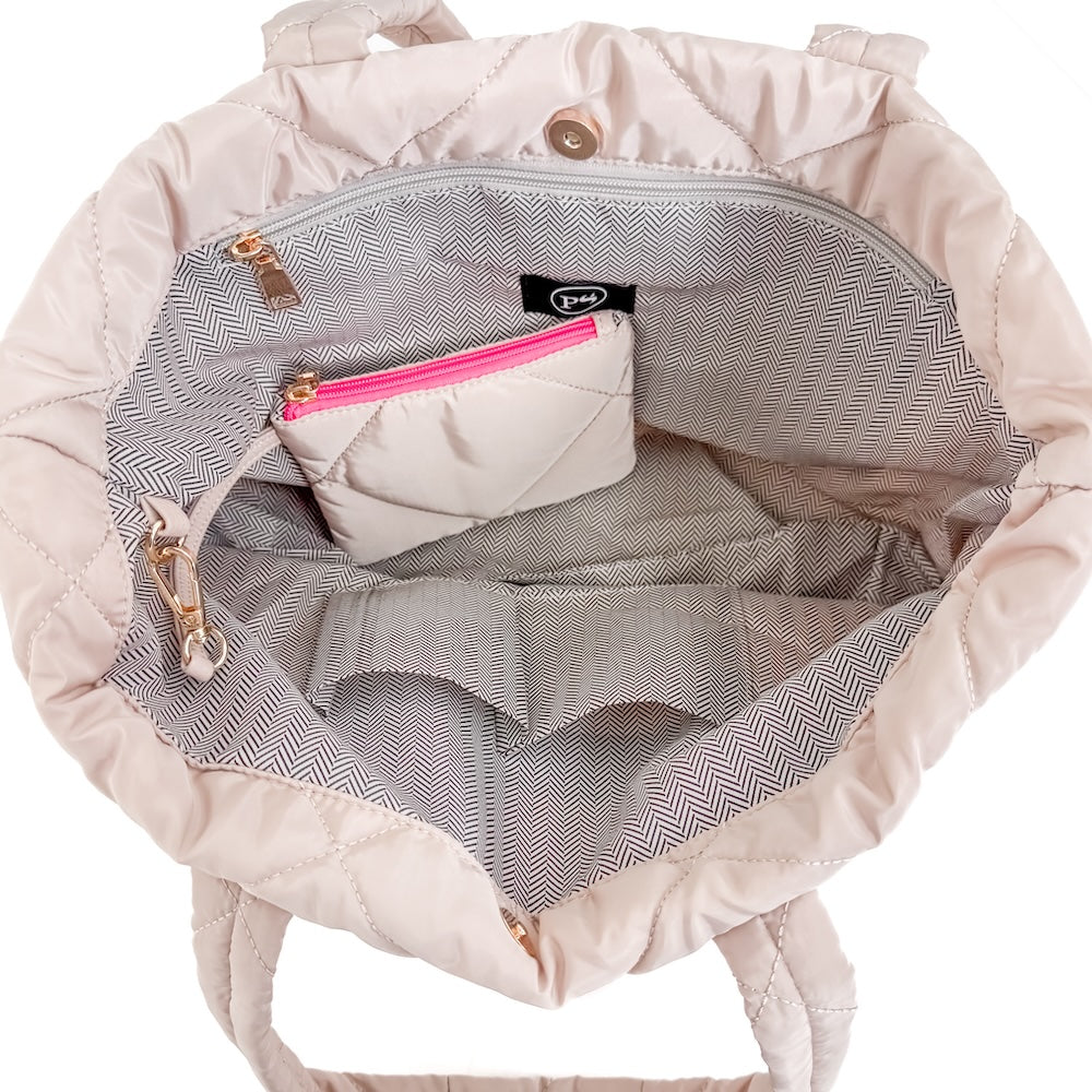 Pink quilted backpack with a zipper pocket on a white background