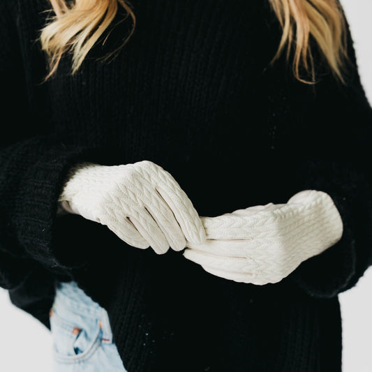 Person wearing white gloves with a blurred background
