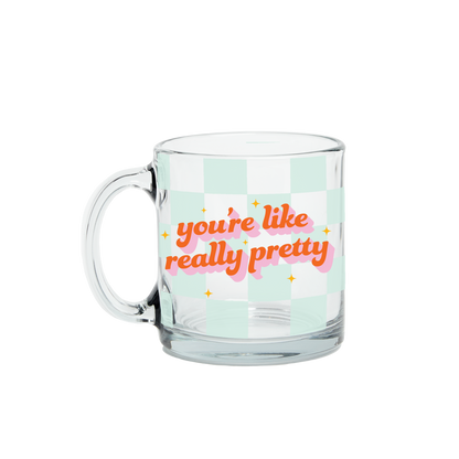 Clear glass mug with 'you're like really pretty' text on a light green background