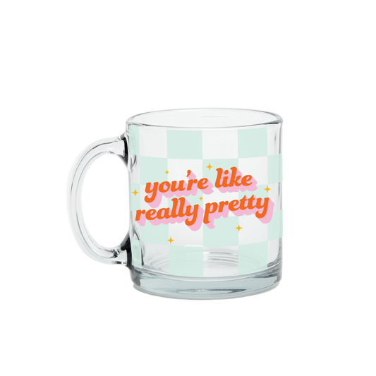 Clear glass mug with 'you're like really pretty' text on a light green background