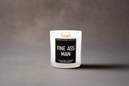 Candle with a label reading 'FINE ASS MAN' on a gray background