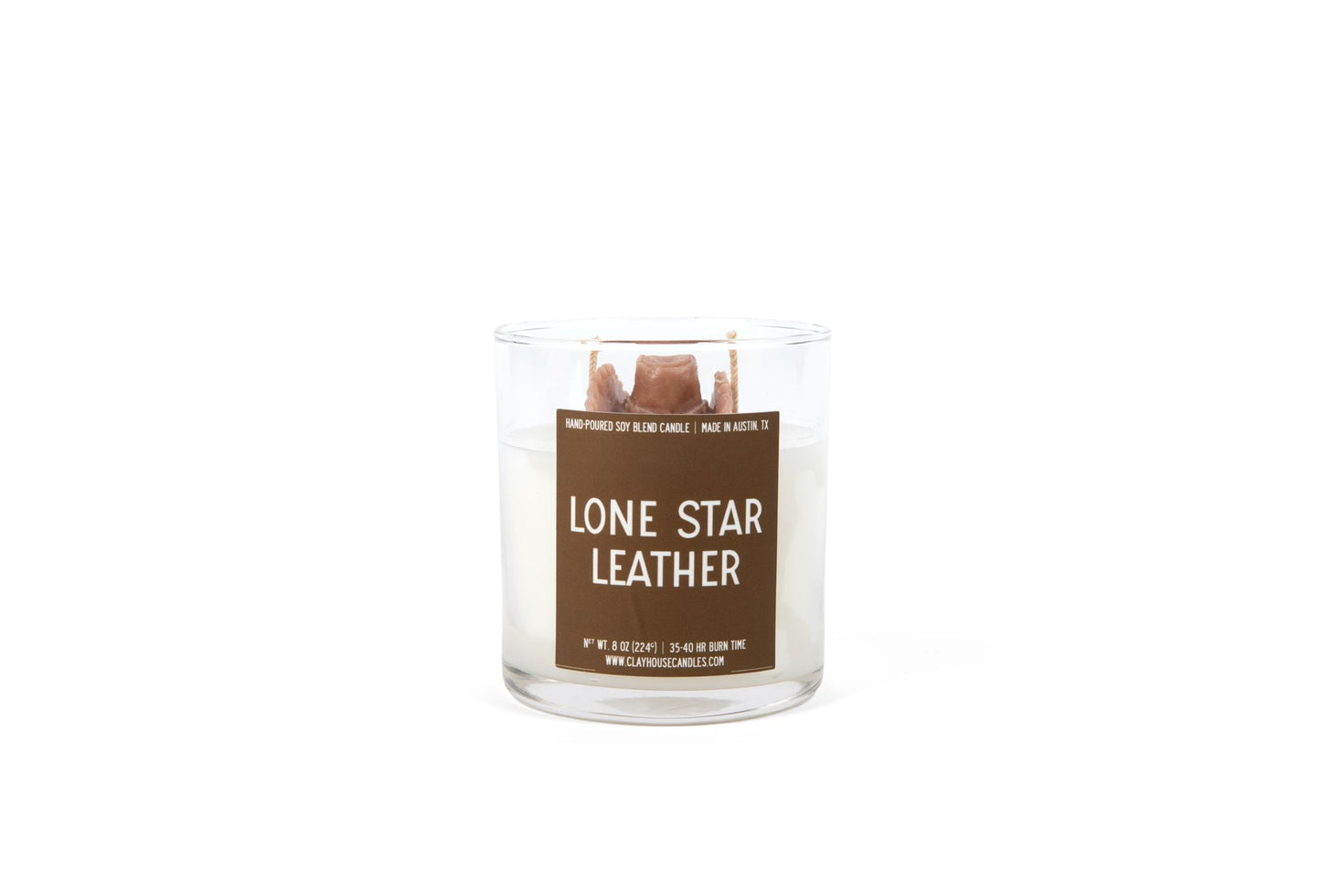 Candle in a glass jar labeled 'Lone Star Leather' on a white background