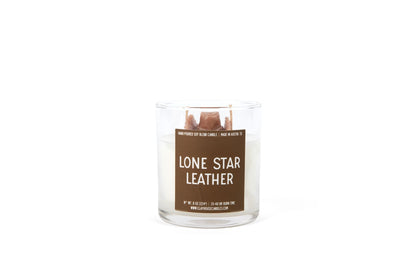 Candle in a glass jar labeled 'Lone Star Leather' on a white background
