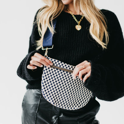 Person holding a checkered handbag with a plain background