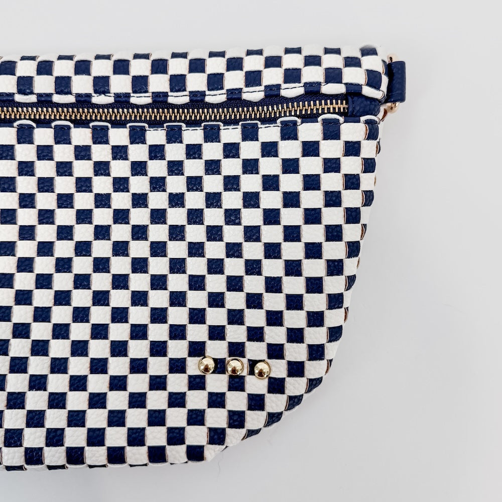 Navy and white checkered pouch with gold zipper on a light gray background