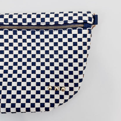 Navy and white checkered pouch with gold zipper on a light gray background