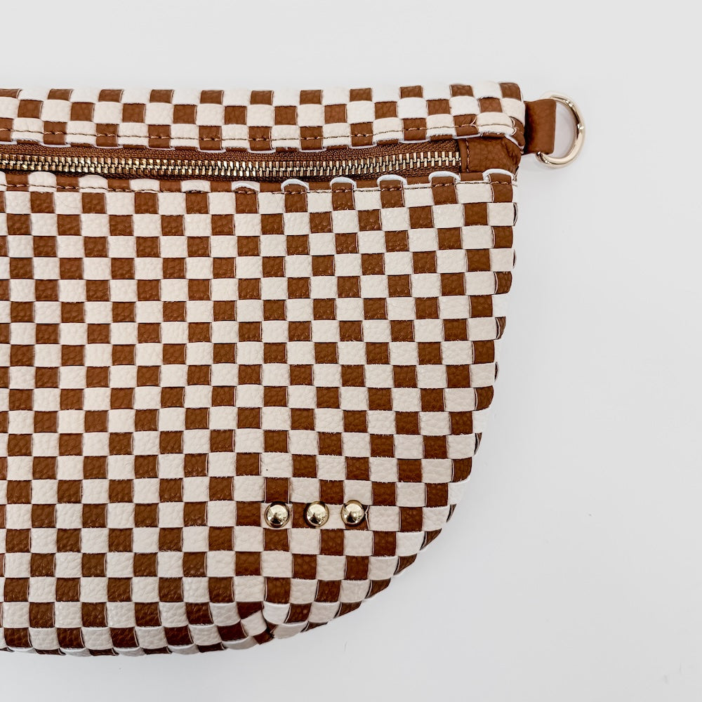 Brown and white checkered bag with a zipper on a light gray background