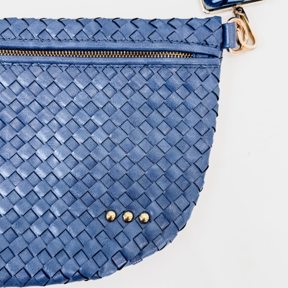 Blue woven clutch bag with gold zipper and hardware on a light background