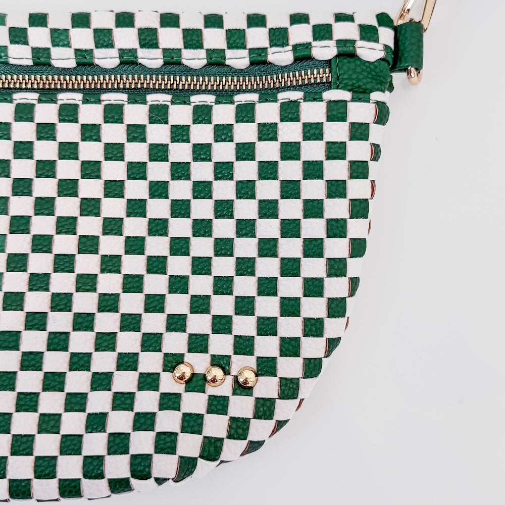 Green and white checkered bag with gold zipper on a light gray background