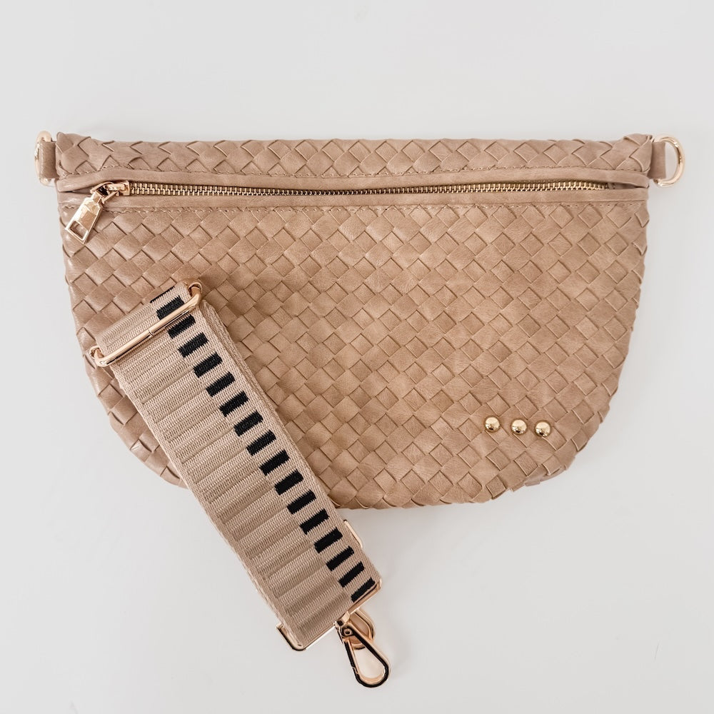 Beige woven handbag with a matching strap on a light gray background